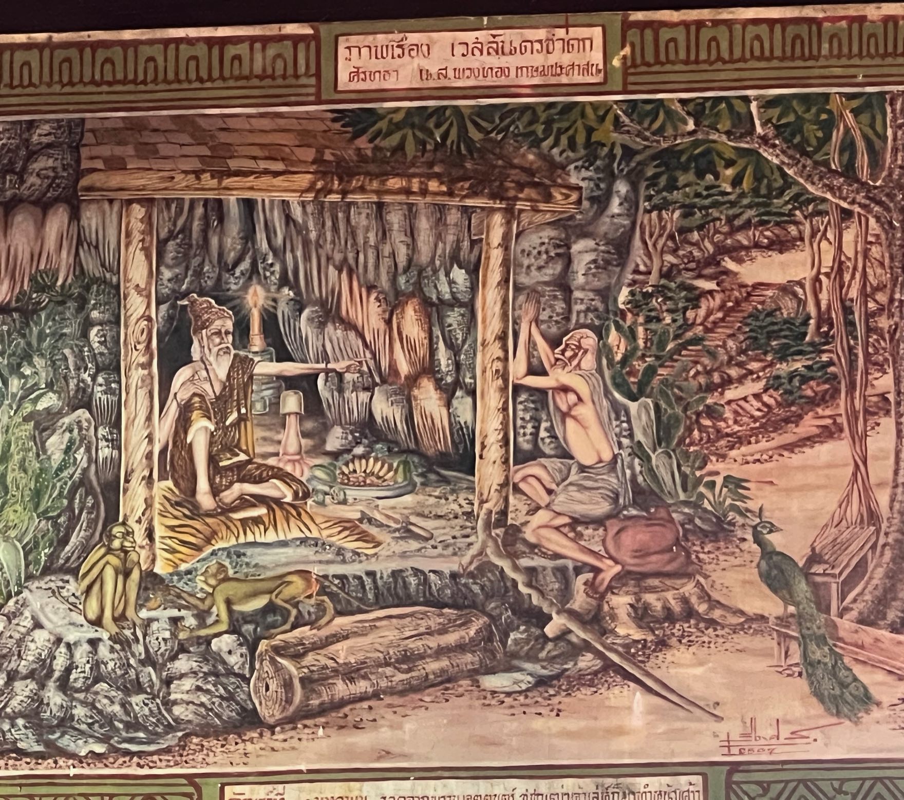 Lanna temple mural: a lersi teaching in a forest cave, a peacock looking on — photographed at a northern wat
